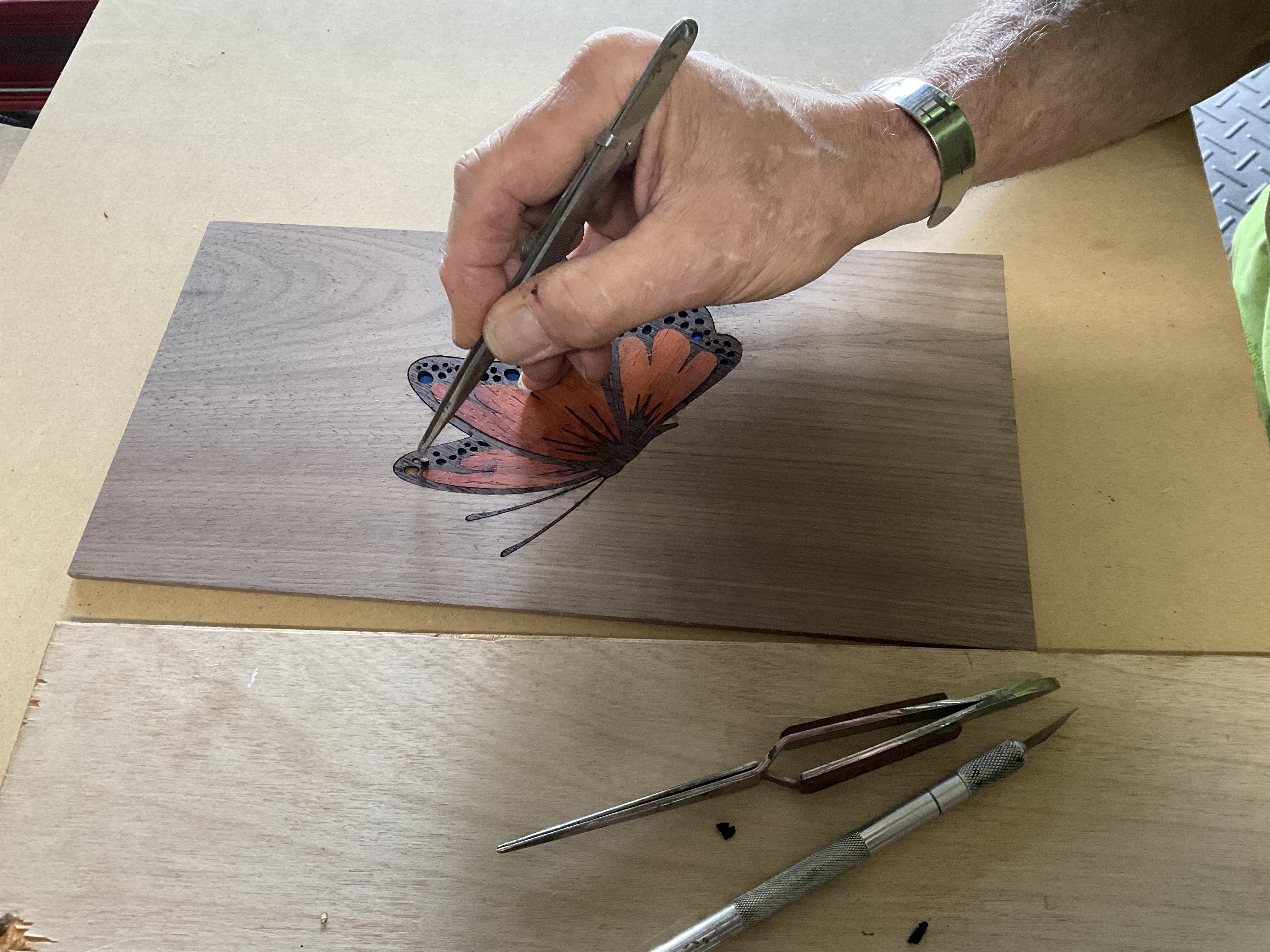 Contrasting butterfly inlay pieces cut from colorful hardwood