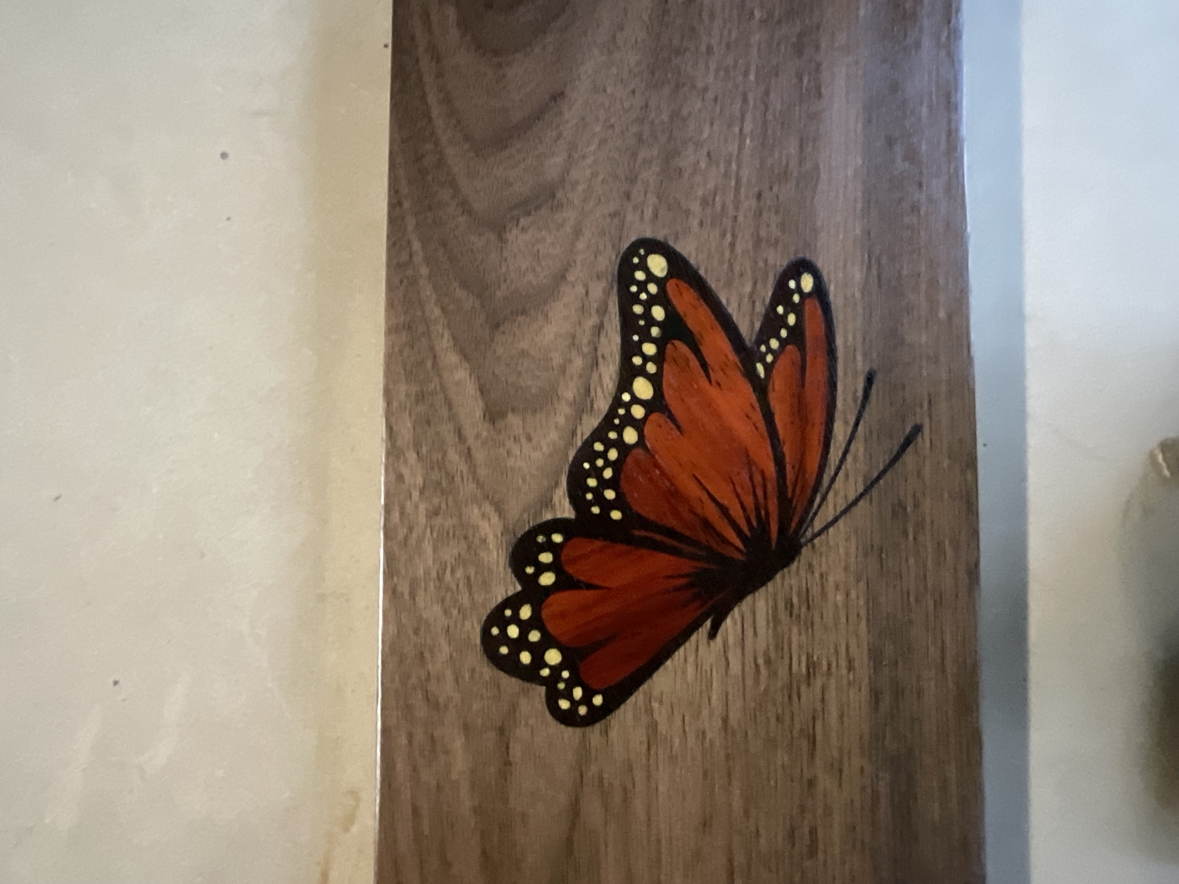 Close detail of the finished butterfly wood inlay after sanding and oil finish