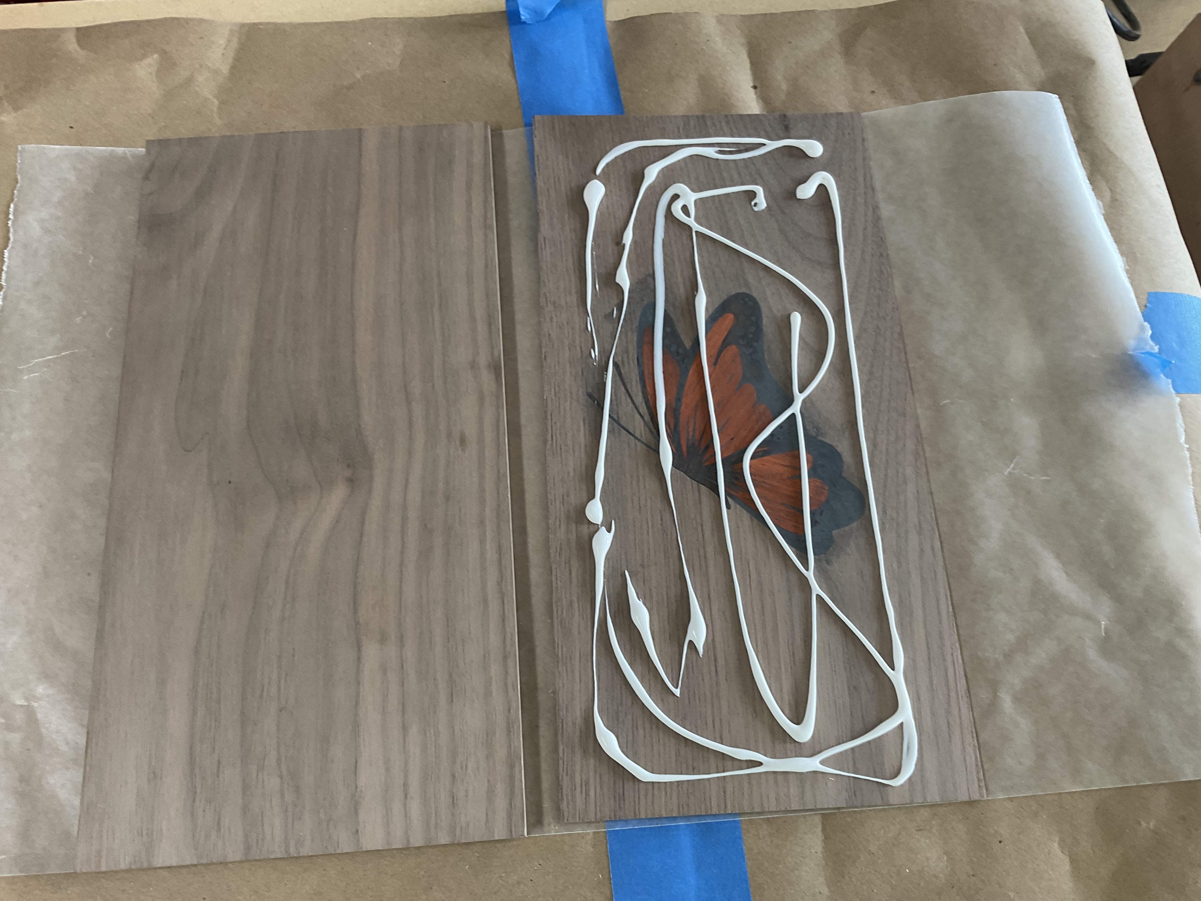 Butterfly inlay clamped between boards during glue-up