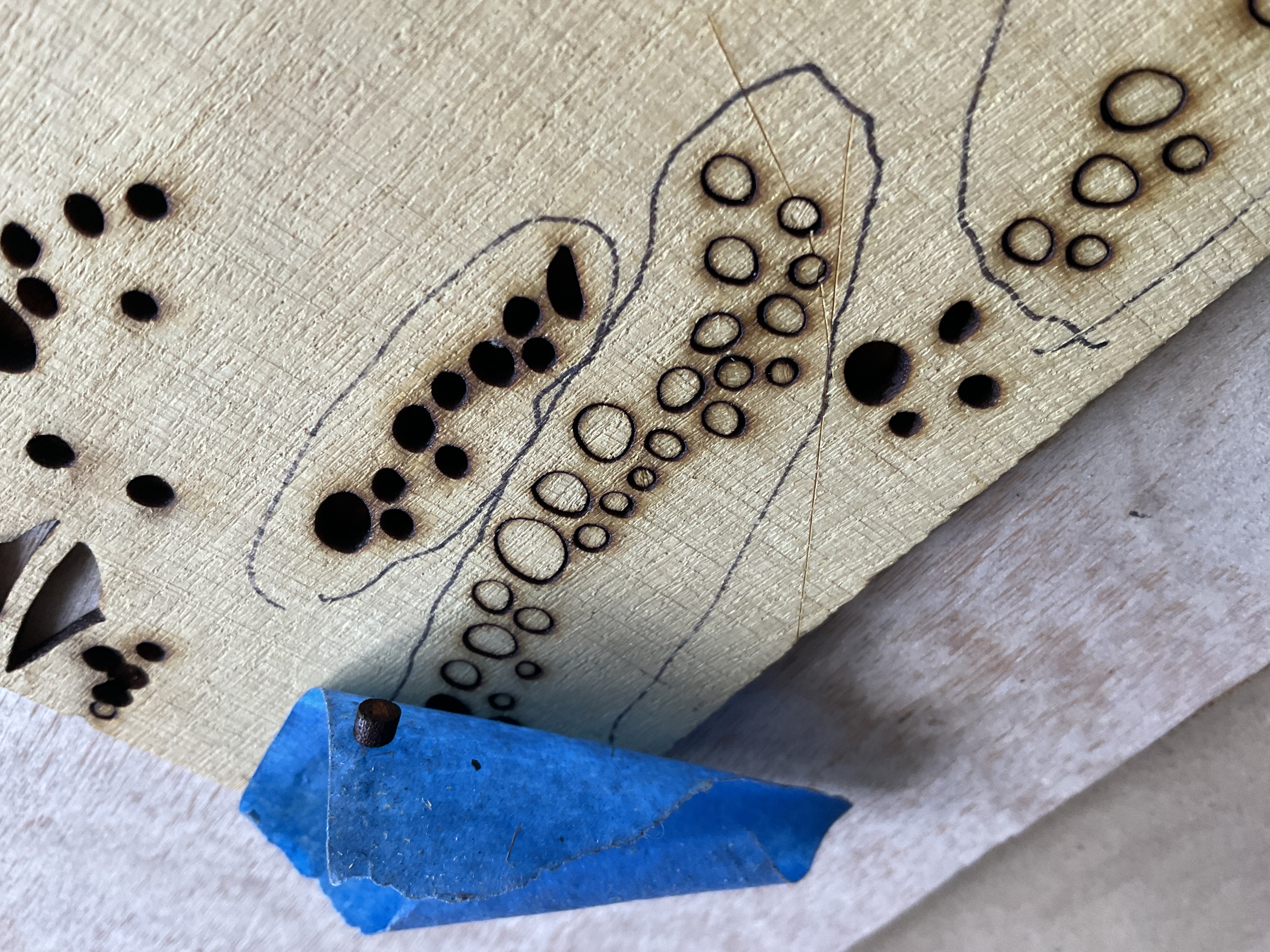 Small yellow heart dots being prepared for placement in the butterfly inlay